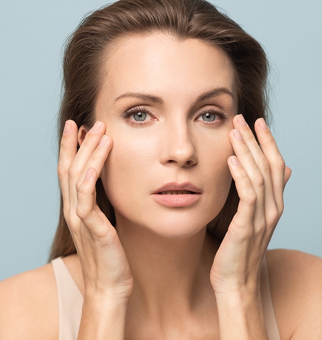 Millennial woman touch healthy skin satisfied with facial treatment Young woman