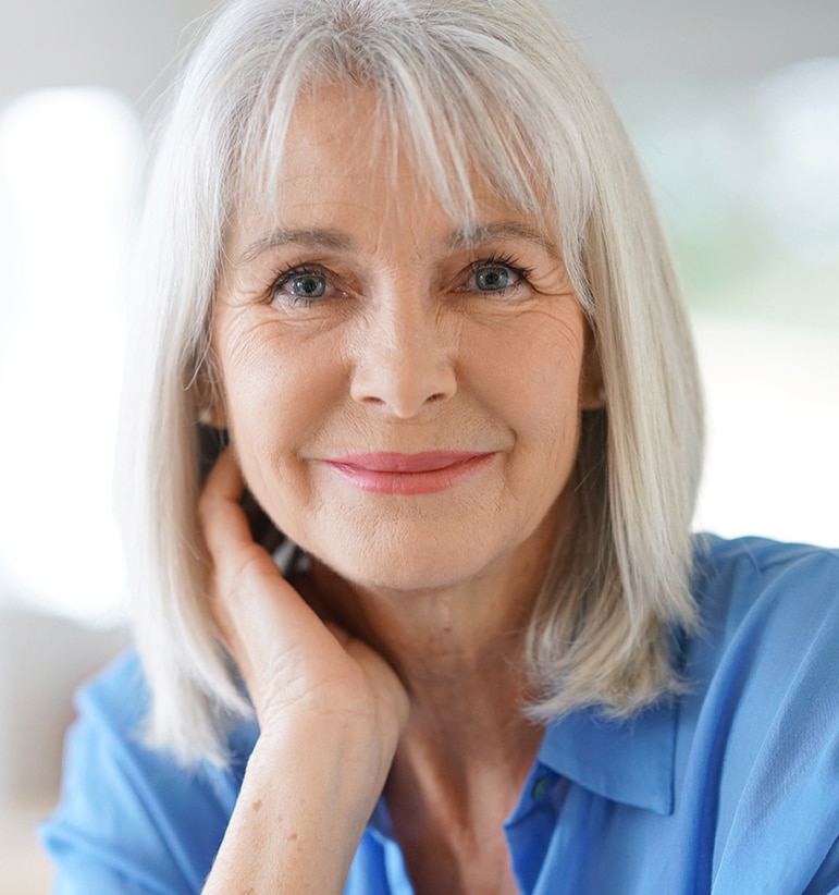 Portrait of senior woman with blue shirt Middle aged woman forehead lift
